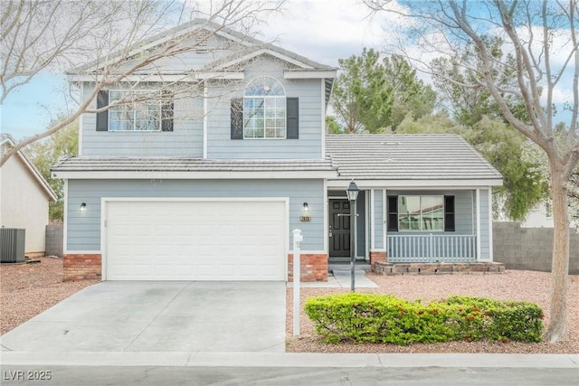 traditional-style home with brick siding, fence, concrete driveway, covered porch, and an attached garage