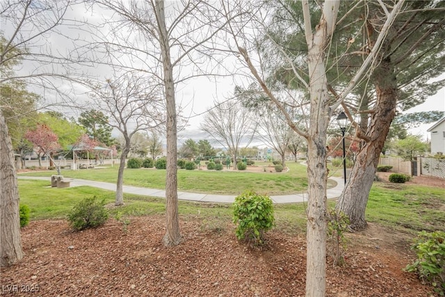 view of community with a yard and fence