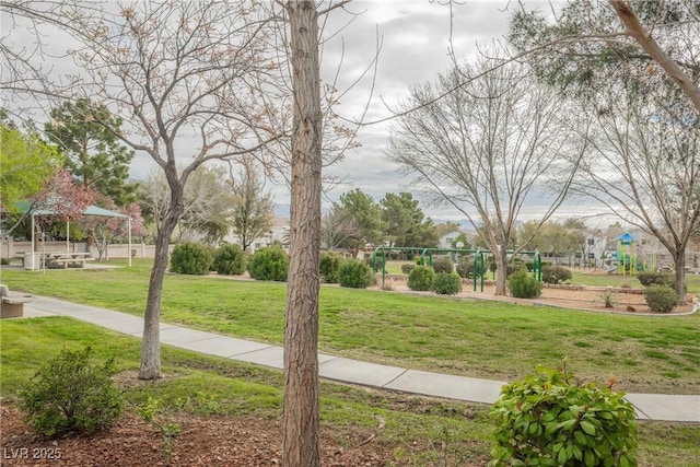 surrounding community with a yard and playground community