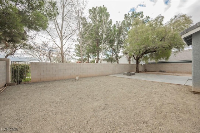 view of yard featuring a patio area, an outdoor fire pit, and a fenced backyard