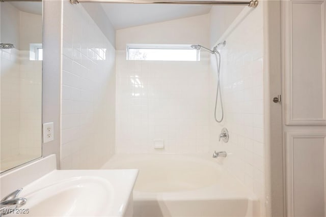 bathroom with vanity, shower / bathing tub combination, and lofted ceiling