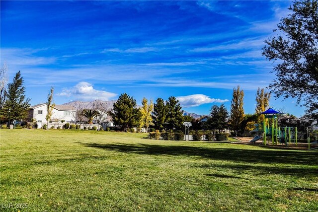 view of yard with a mountain view and playground community