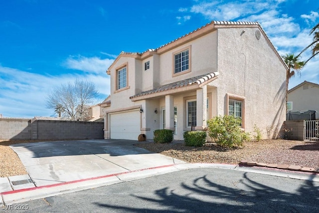 mediterranean / spanish-style house with fence, stucco siding, concrete driveway, a garage, and a tile roof