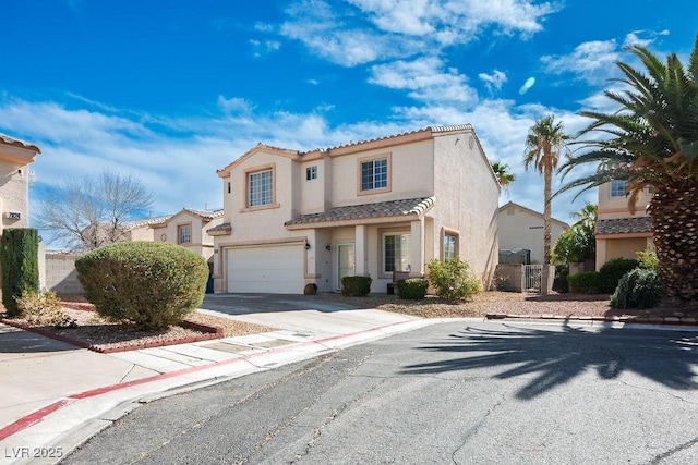 mediterranean / spanish house featuring a garage, a tile roof, driveway, and stucco siding