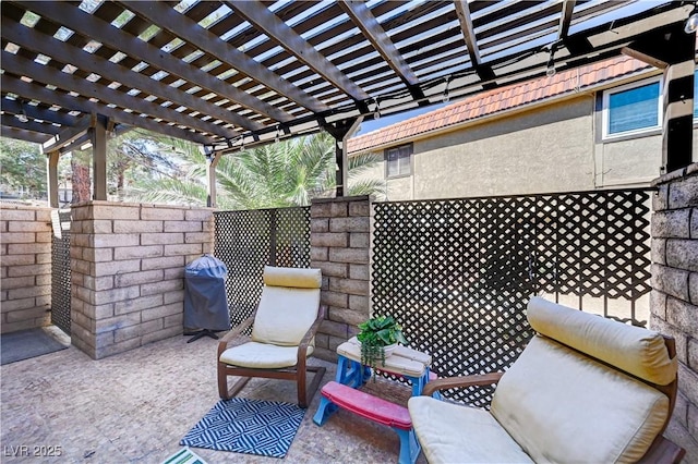 view of patio featuring a grill, a pergola, and fence