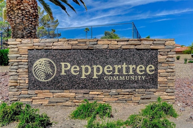 community / neighborhood sign featuring fence