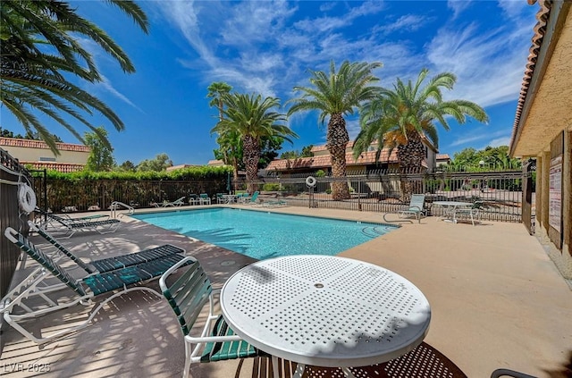 pool featuring a patio area and fence