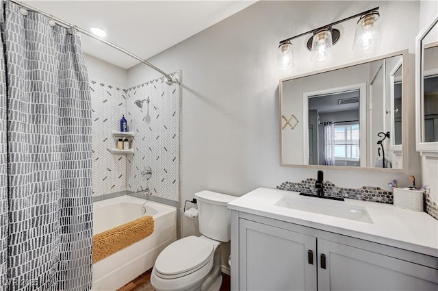 full bathroom featuring toilet, vanity, and shower / bath combination with curtain