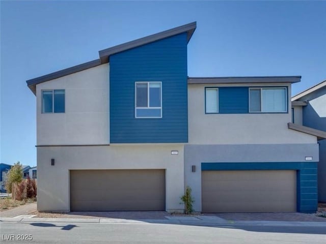 contemporary house featuring an attached garage and stucco siding