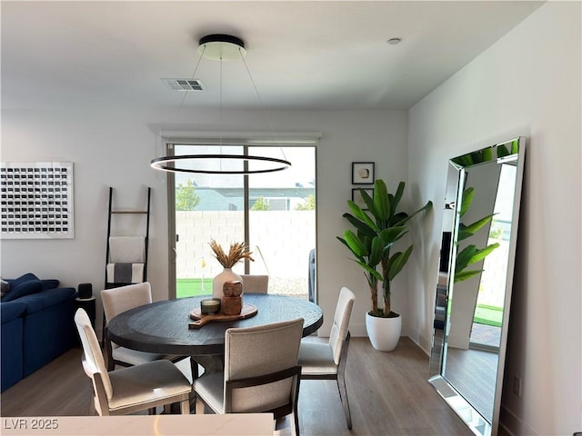 dining room with wood finished floors and visible vents