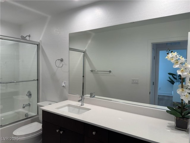 bathroom with visible vents, enclosed tub / shower combo, toilet, and vanity