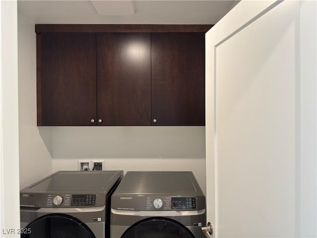 laundry room with washer and dryer and cabinet space