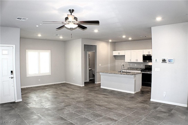 kitchen featuring visible vents, white cabinetry, stainless steel microwave, range, and open floor plan