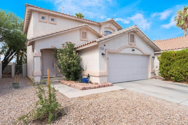 mediterranean / spanish home with stucco siding, an attached garage, driveway, and fence