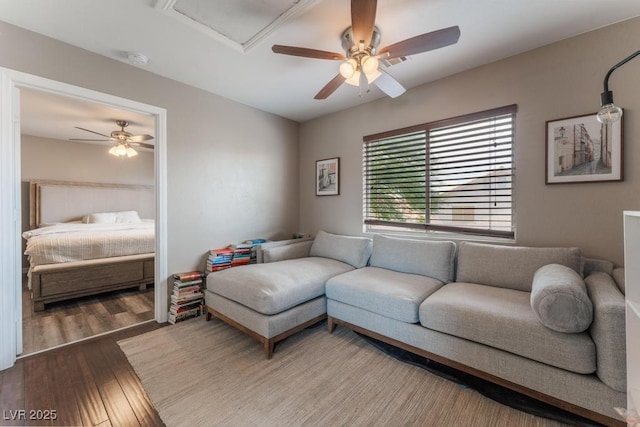 living room featuring a ceiling fan and wood-type flooring