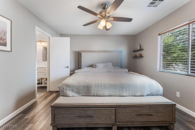 bedroom with visible vents, a ceiling fan, wood finished floors, connected bathroom, and baseboards