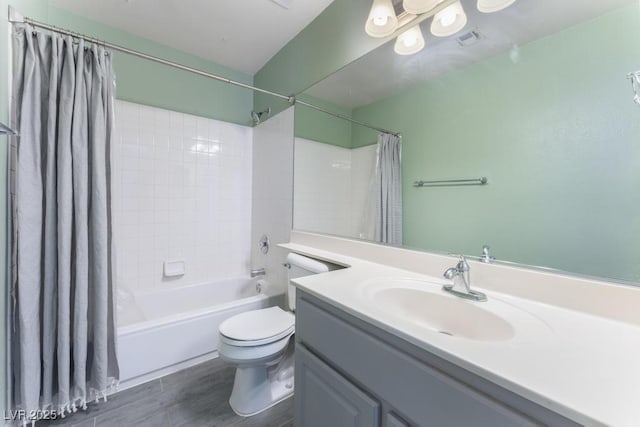 bathroom with vanity, wood finished floors, visible vents, shower / bath combo, and toilet