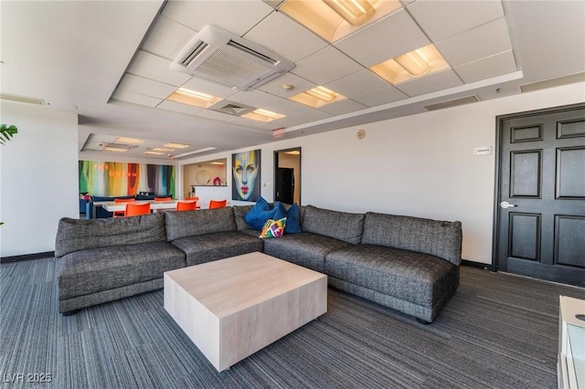 living room featuring baseboards and dark colored carpet