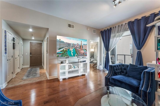 entryway featuring wood finished floors, visible vents, and baseboards