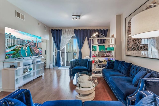 living area with wood finished floors and visible vents