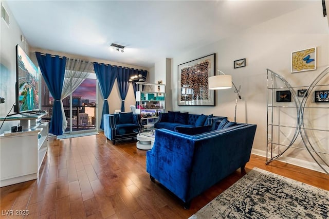 living room with visible vents and wood finished floors