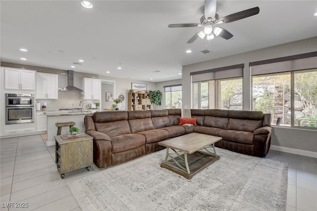 living area with visible vents, baseboards, light tile patterned floors, recessed lighting, and a ceiling fan