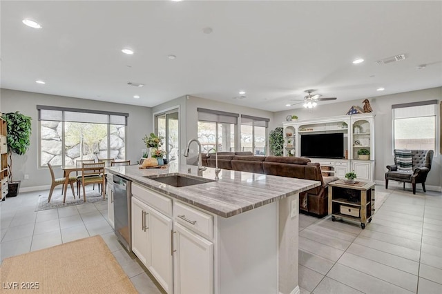 kitchen featuring light tile patterned floors, visible vents, dishwasher, and a sink