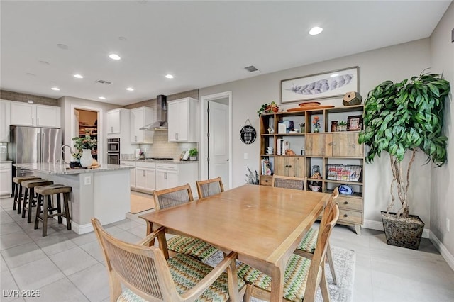 dining room with light tile patterned floors, visible vents, and recessed lighting