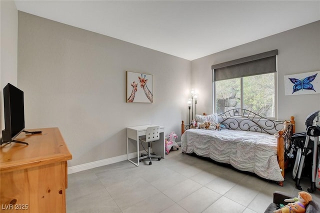 bedroom featuring light tile patterned floors and baseboards