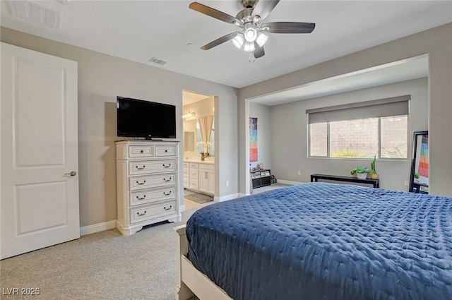 bedroom featuring light carpet, visible vents, ensuite bathroom, and baseboards