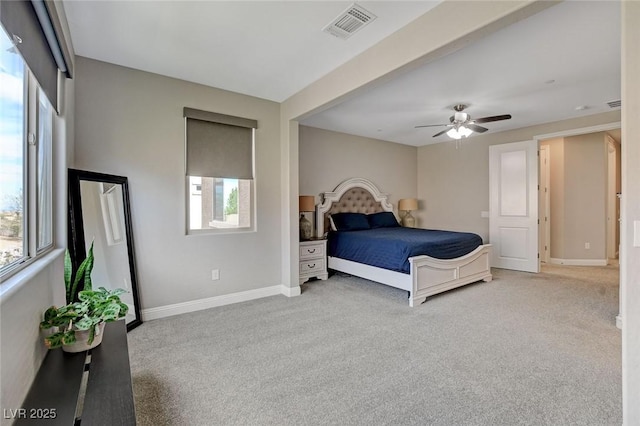 carpeted bedroom featuring visible vents, a ceiling fan, and baseboards