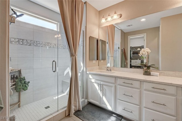 full bathroom with a stall shower and vanity