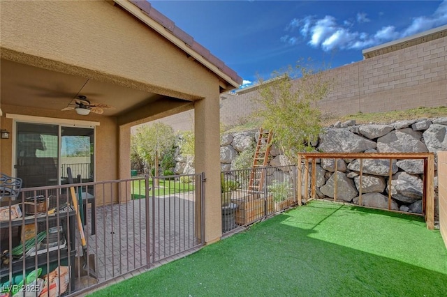 view of yard featuring ceiling fan, a fenced backyard, and a patio area