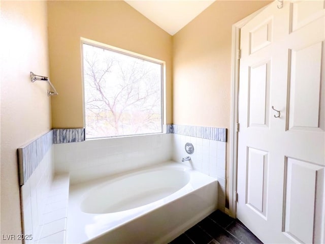 full bath with tile patterned floors and a bath