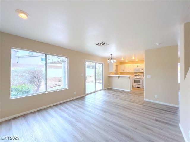 unfurnished living room with visible vents, baseboards, light wood-style flooring, and a chandelier