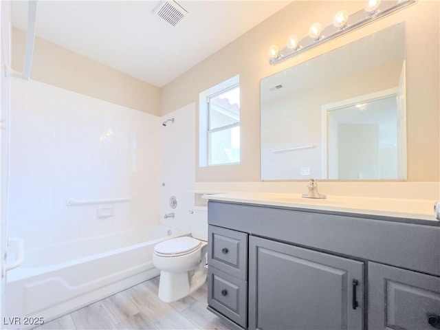 bathroom with vanity, toilet, tub / shower combination, and visible vents