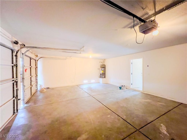 garage featuring strapped water heater and a garage door opener