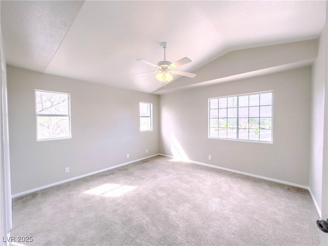 carpeted spare room with baseboards, a ceiling fan, and vaulted ceiling