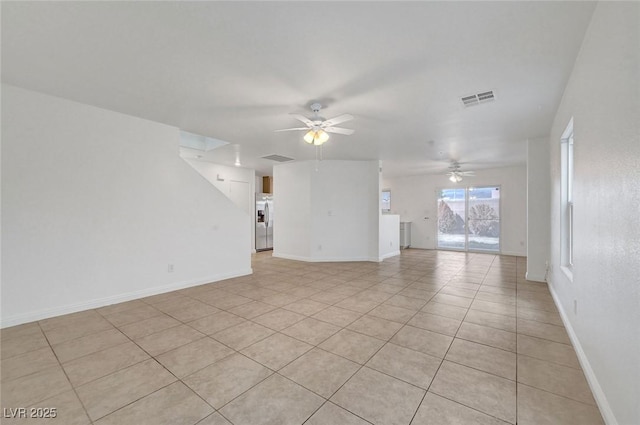 unfurnished living room featuring visible vents, baseboards, and a ceiling fan