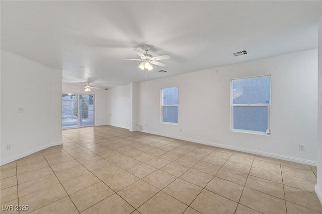 spare room featuring visible vents, baseboards, and ceiling fan