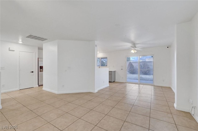 unfurnished room featuring light tile patterned floors, visible vents, baseboards, and a ceiling fan