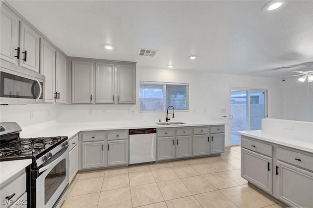 kitchen featuring a sink, visible vents, gray cabinets, and stainless steel appliances