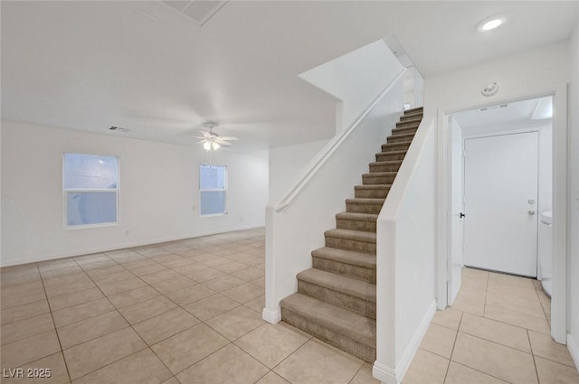 staircase featuring visible vents, baseboards, a ceiling fan, and tile patterned flooring