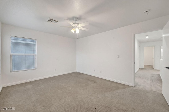 unfurnished room featuring visible vents, baseboards, carpet, and a ceiling fan