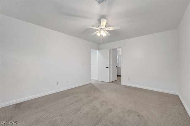 carpeted empty room with baseboards and ceiling fan