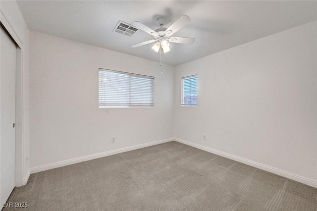 unfurnished bedroom featuring baseboards, visible vents, carpet floors, and a closet