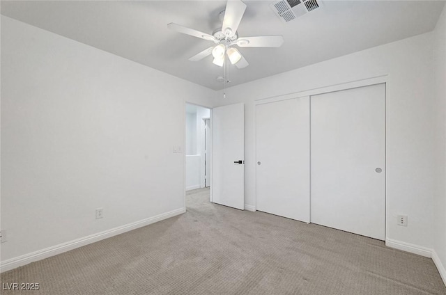 unfurnished bedroom featuring a closet, baseboards, visible vents, and carpet floors