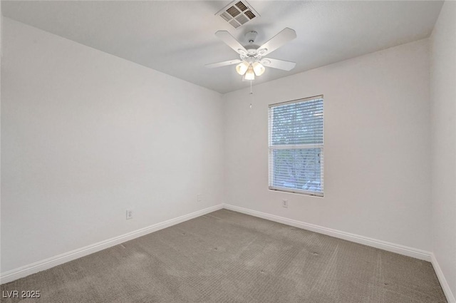 empty room featuring visible vents, carpet flooring, baseboards, and ceiling fan