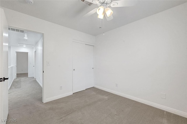 unfurnished bedroom featuring carpet flooring, baseboards, visible vents, and a closet