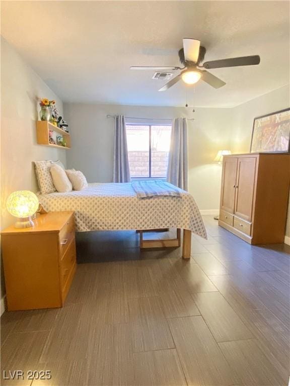 bedroom featuring dark wood finished floors, visible vents, baseboards, and ceiling fan